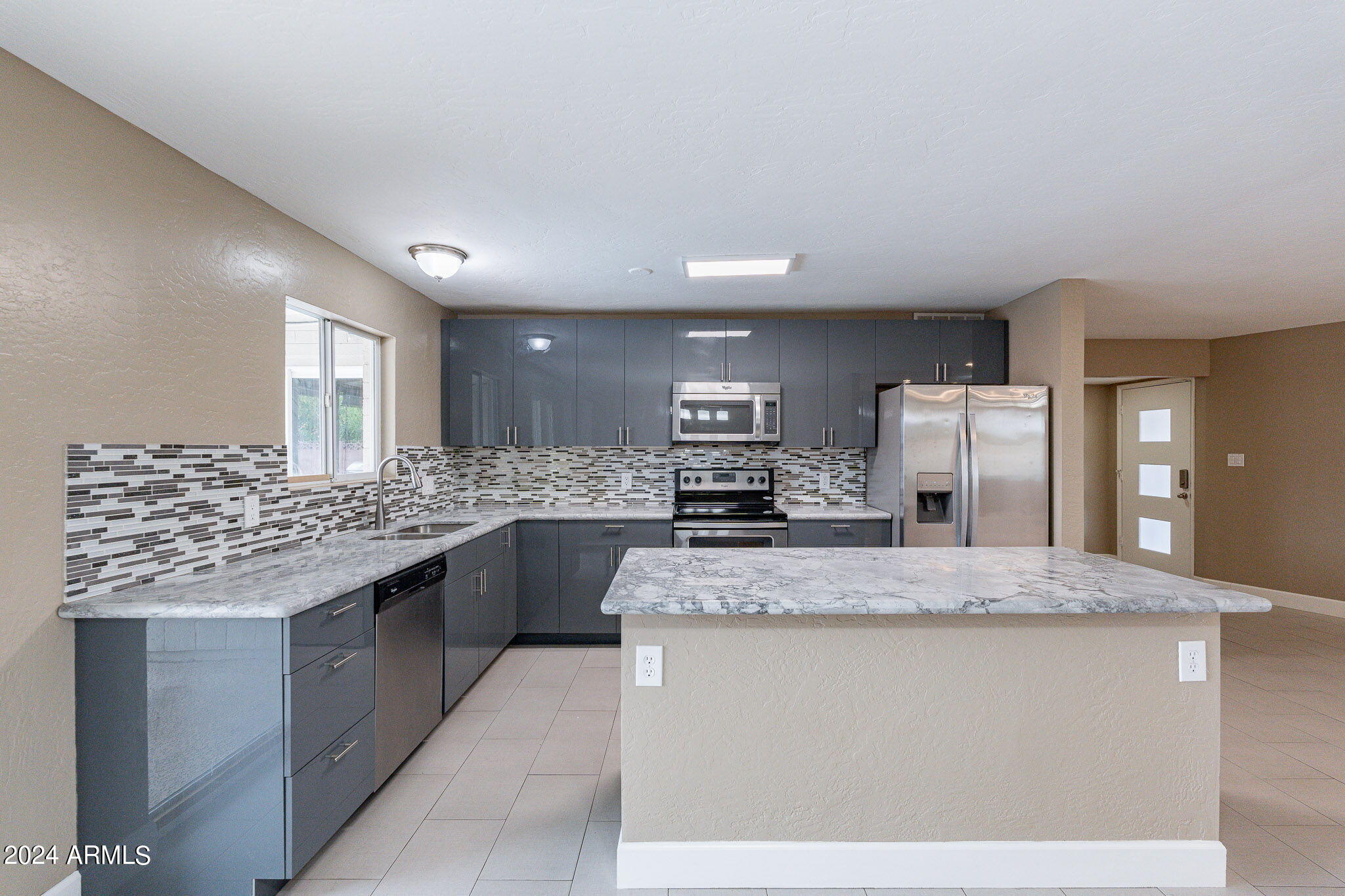 1320 East Orchid Lane Phoenix, AZ 85020 - Photo 20 of 48 a kitchen with stainless steel appliances granite countertop a sink stove and refrigerator