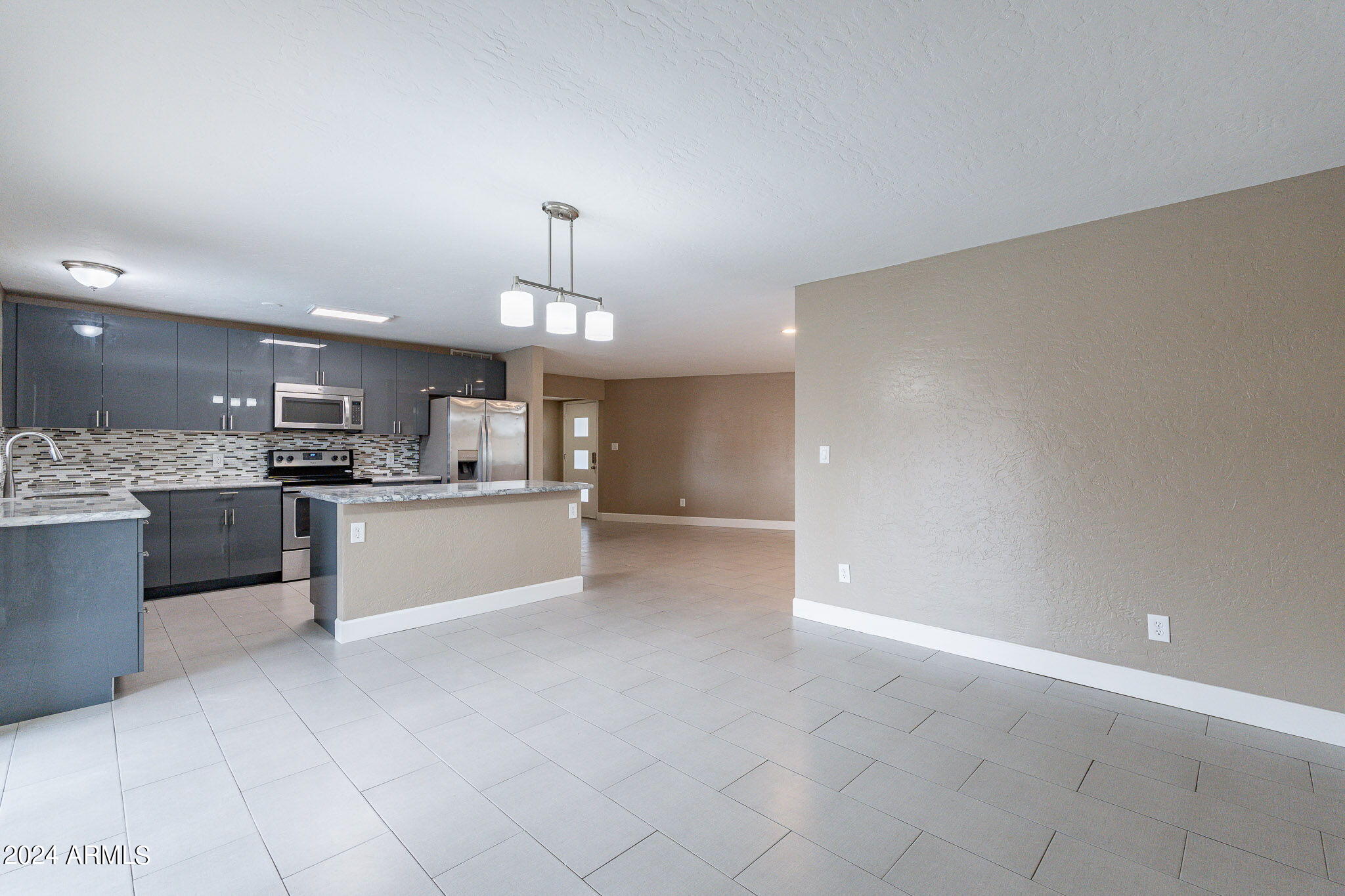 1320 East Orchid Lane Phoenix, AZ 85020 - Photo 23 of 48 a large kitchen with kitchen island a sink stainless steel appliances and cabinets