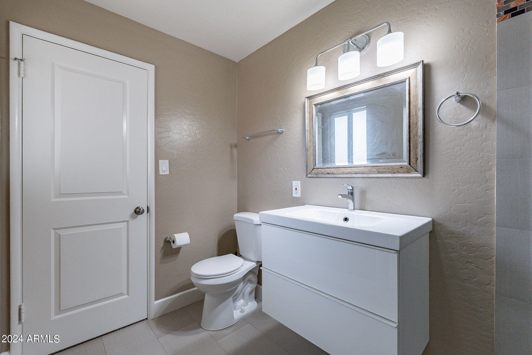 1320 East Orchid Lane Phoenix, AZ 85020 - Photo 28 of 48 a bathroom with a toilet a sink and mirror