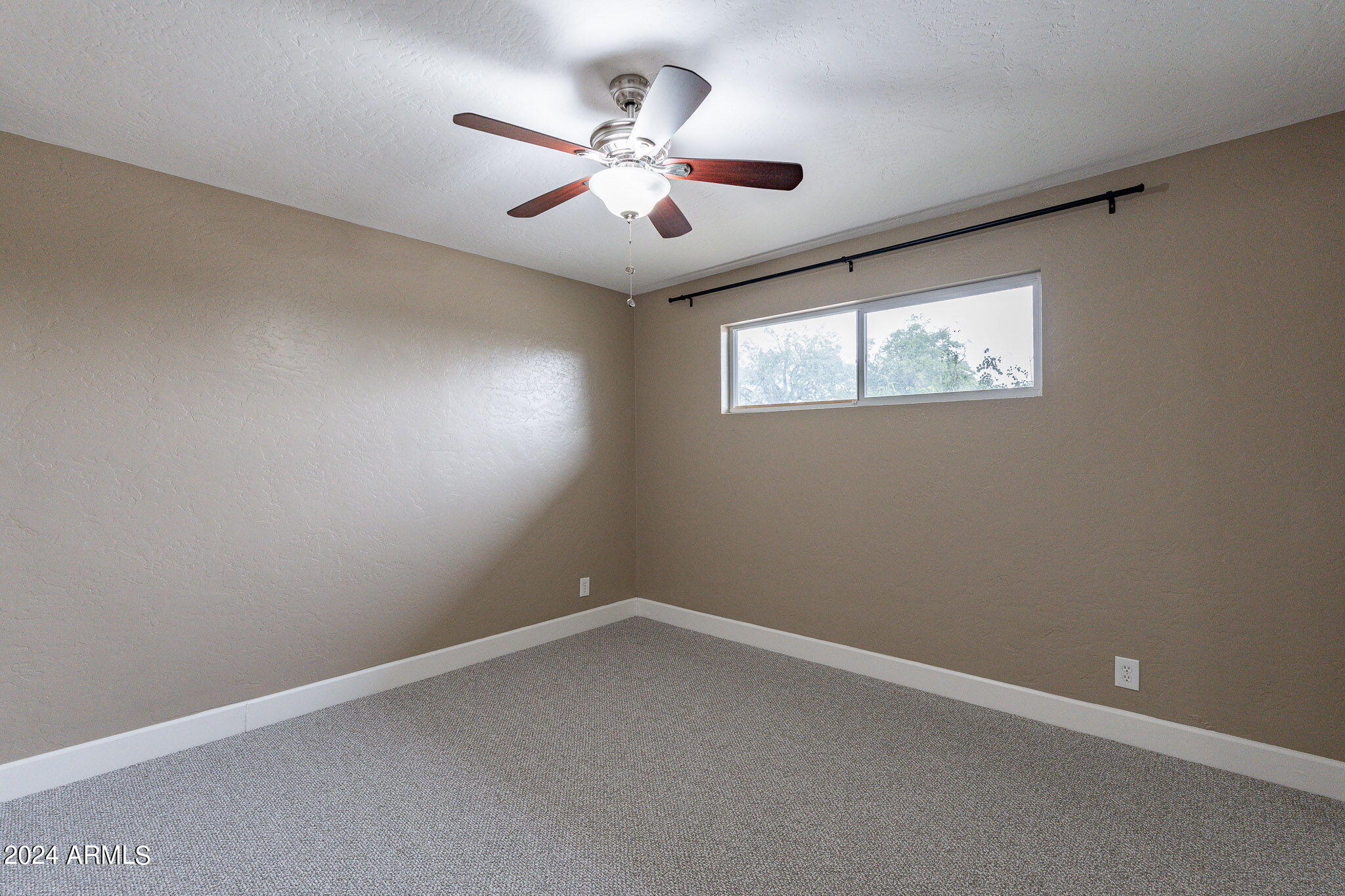 1320 East Orchid Lane Phoenix, AZ 85020 - Photo 31 of 48 an empty room with windows and fan
