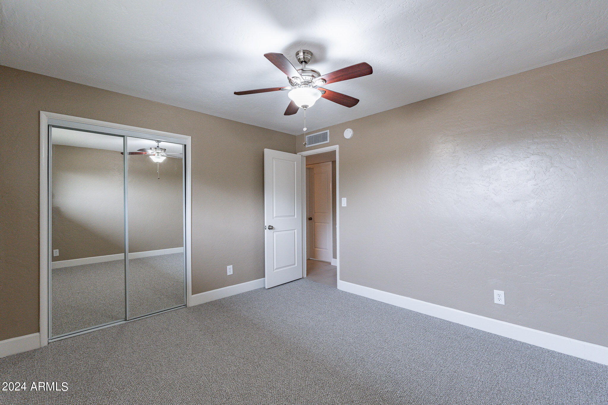 1320 East Orchid Lane Phoenix, AZ 85020 - Photo 32 of 48 a view of an empty room with a ceiling fan