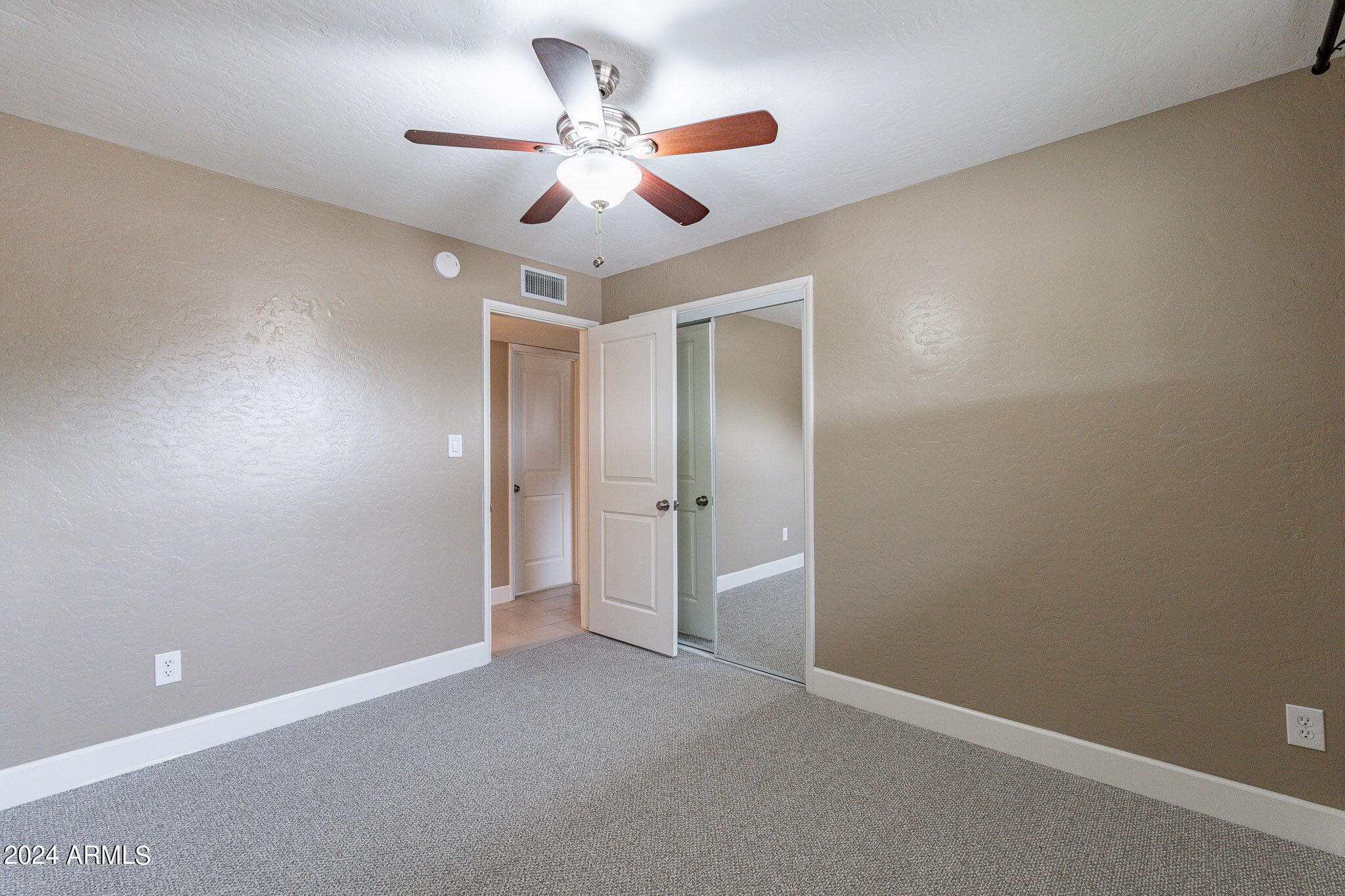 1320 East Orchid Lane Phoenix, AZ 85020 - Photo 34 of 48 an empty room with a fan and a fan