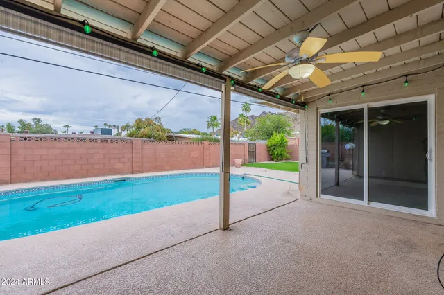 a view of a swimming pool and lounge chair