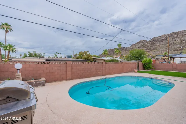 a view of a house with swimming pool and furniture