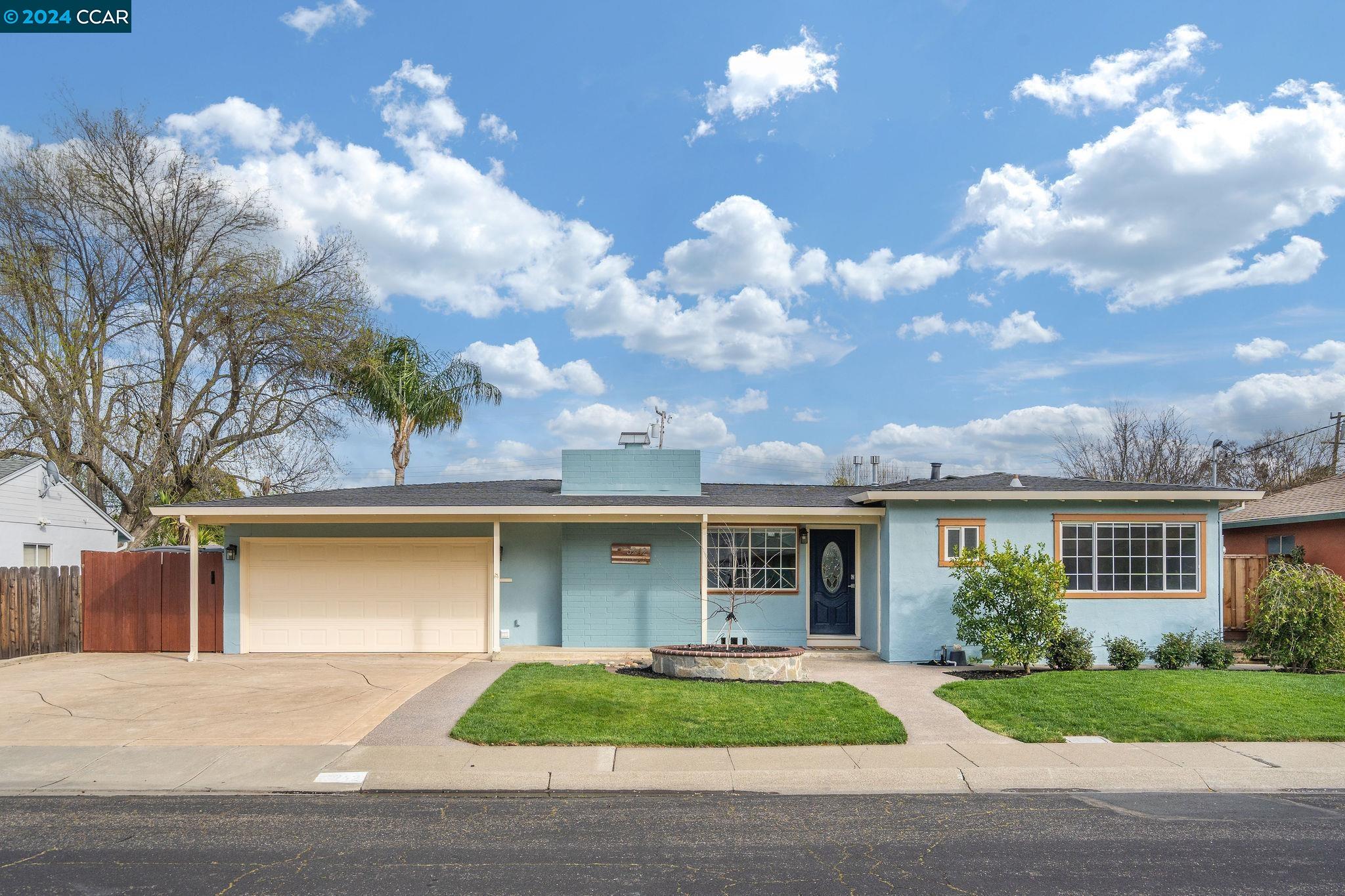 a front view of a house with garden
