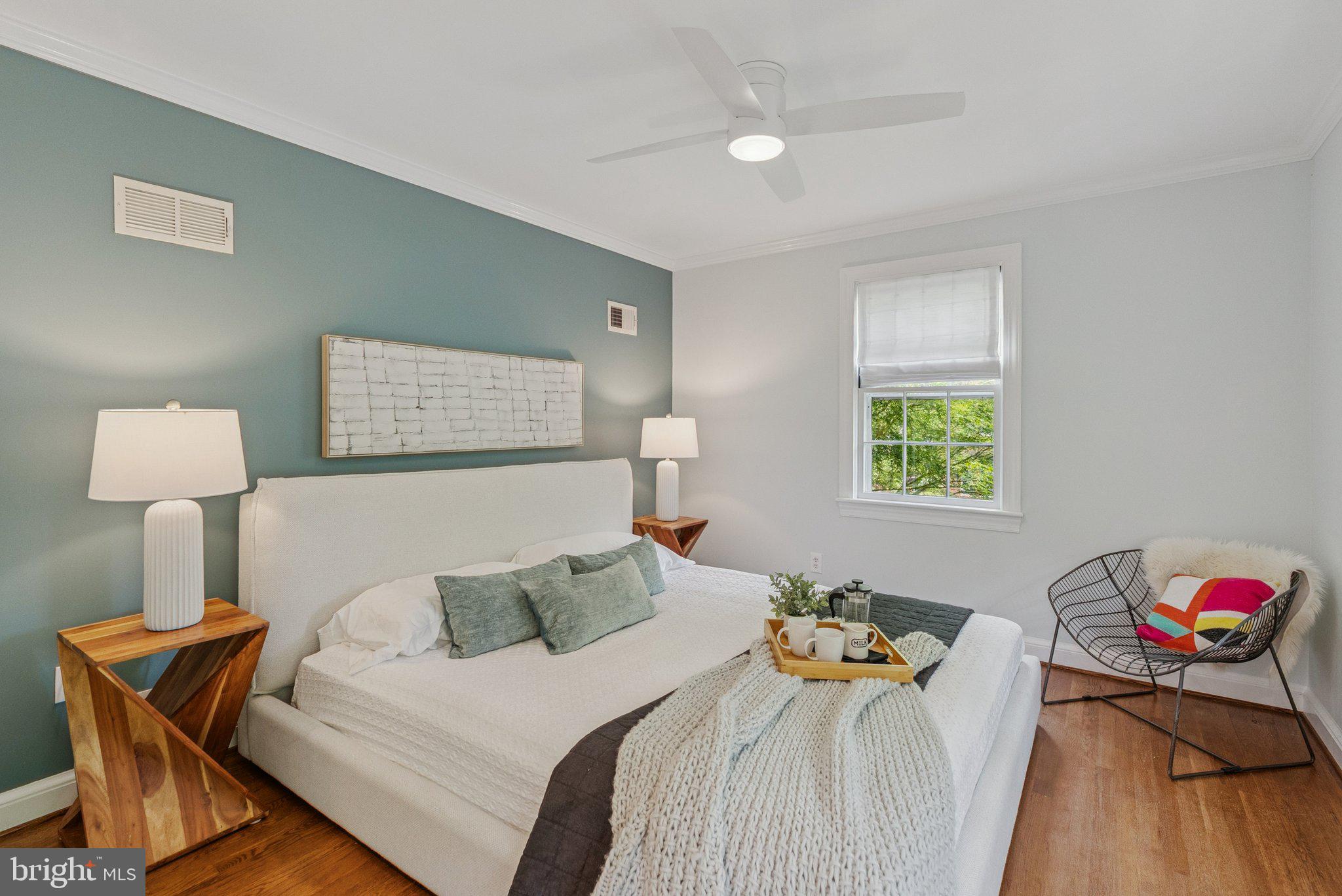 657 E Street Southeast Washington, DC 20003 - Photo 17 of 41 a bedroom with a bed and a lamp