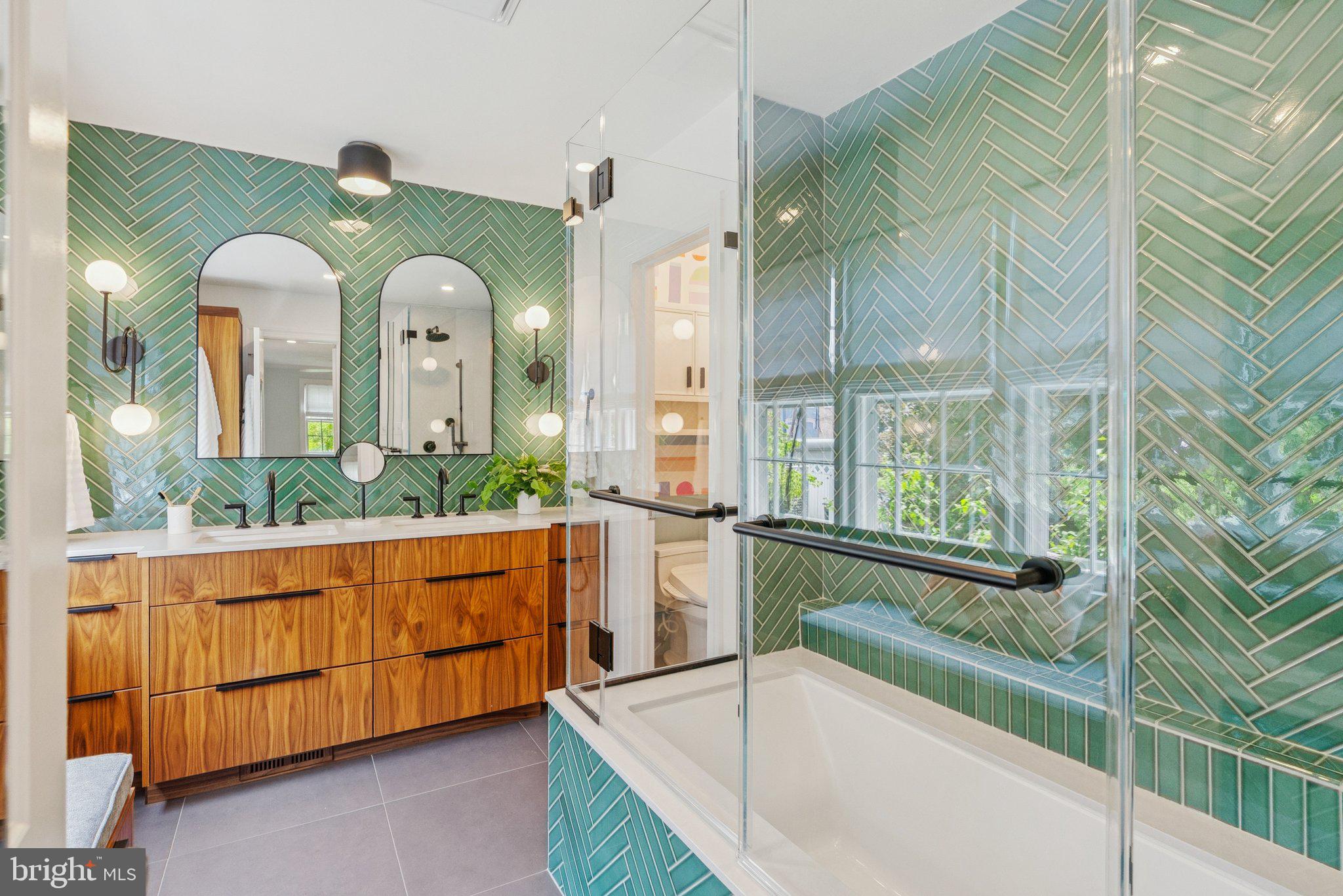 657 E Street Southeast Washington, DC 20003 - Photo 20 of 41 a bathroom with a granite countertop tub a double vanity sink and a large mirror
