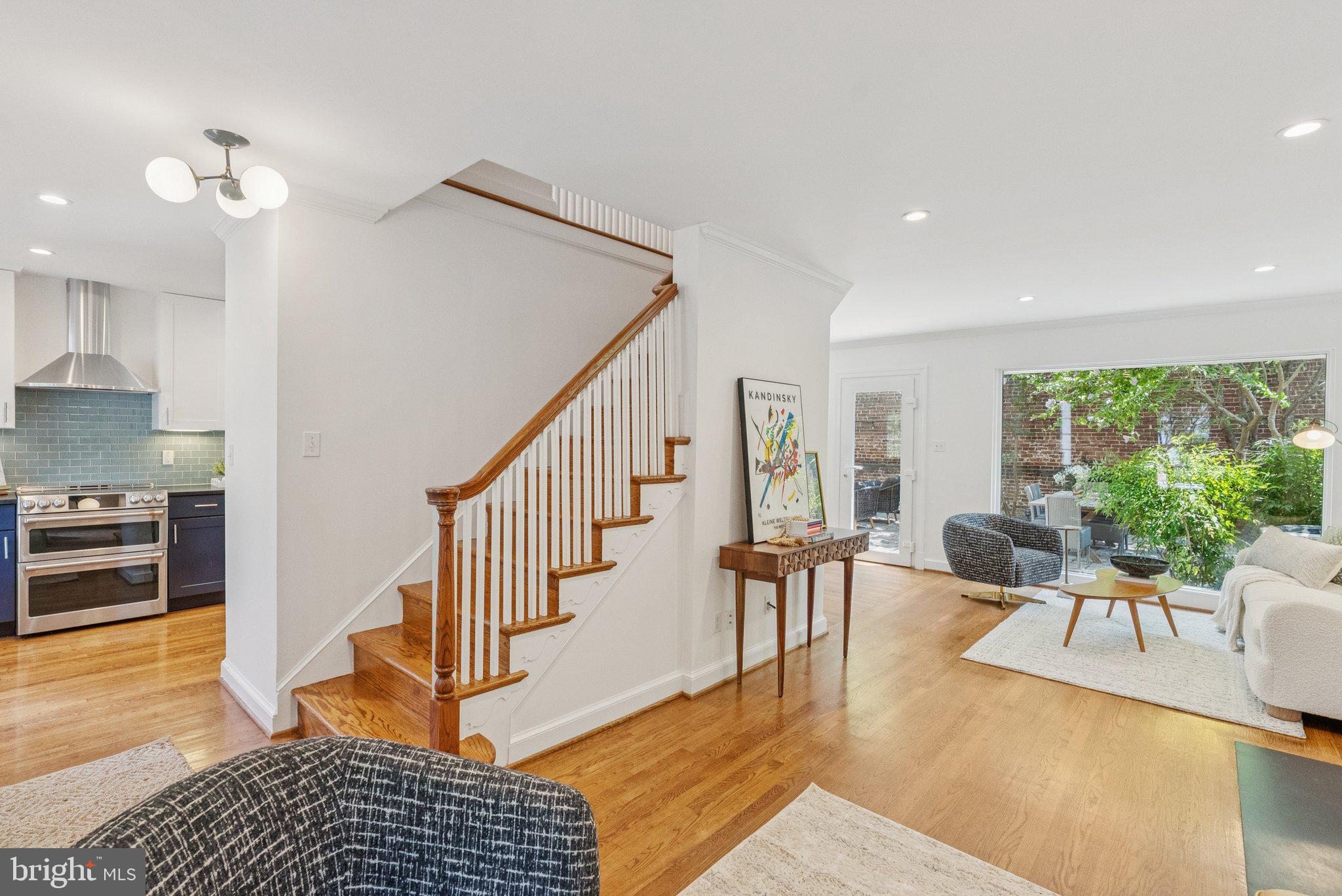 657 E Street Southeast Washington, DC 20003 - Photo 8 of 41 a living room with furniture and a dining table with wooden floor