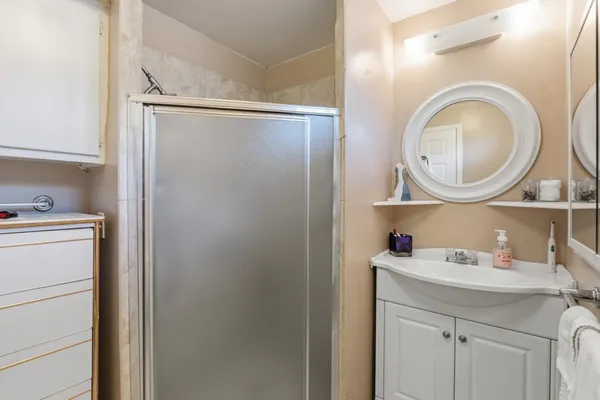 a bathroom with a sink mirror vanity and a toilet