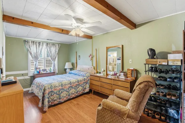 a bedroom with furniture and a large window