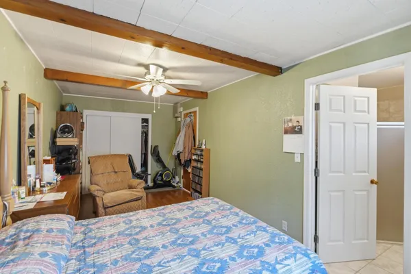 a bedroom with a bed couch and a window