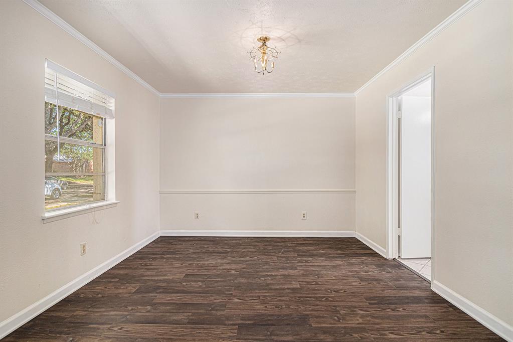 1814 Addington Drive Carrollton, TX 75007 - Photo 5 of 24 Spare room featuring ornamental molding and dark hardwood / wood-style floors