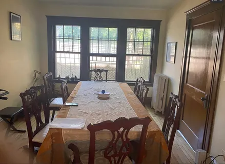 a view of a dining room with furniture and a window