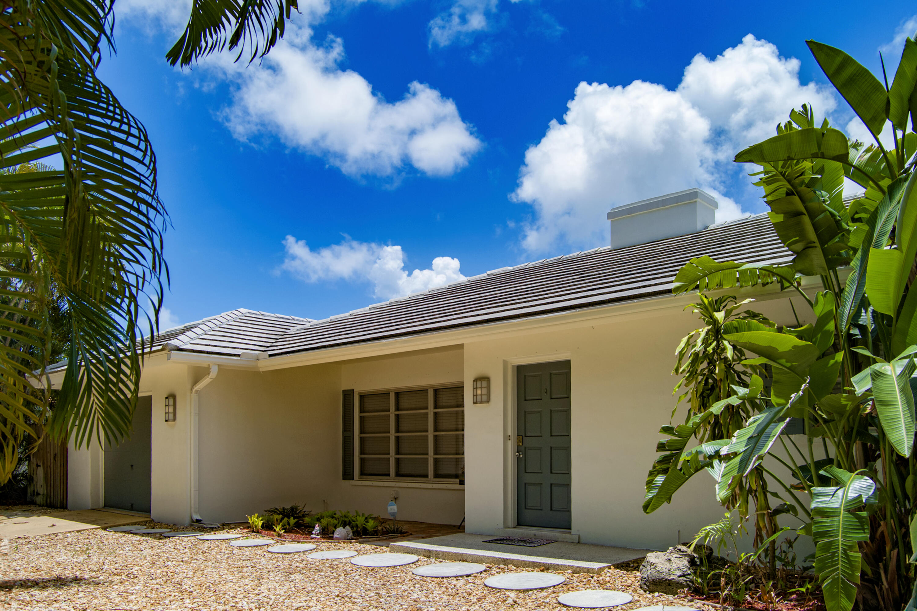 1348 Southwest 4th Street Boca Raton, FL 33486 - Photo 1 of 44 a view of a house with a potted plant and floor to ceiling windows