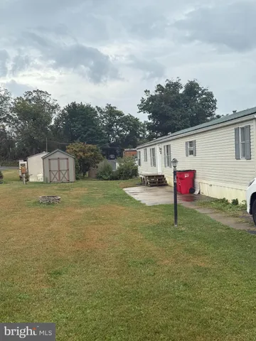 a house view with swimming pool in front of it
