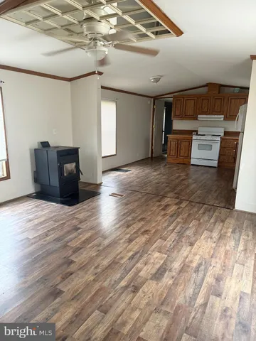a view of empty room with wooden floor