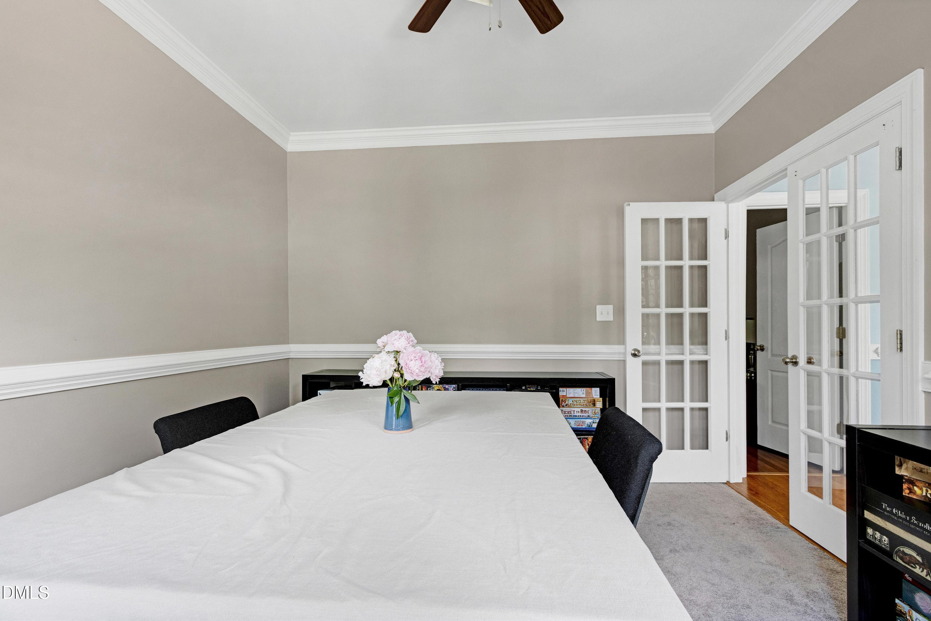 1320 Taylor Farm Road Raleigh, NC 27603 - Photo 10 of 56 a bedroom with a bed and a tv on the dresser