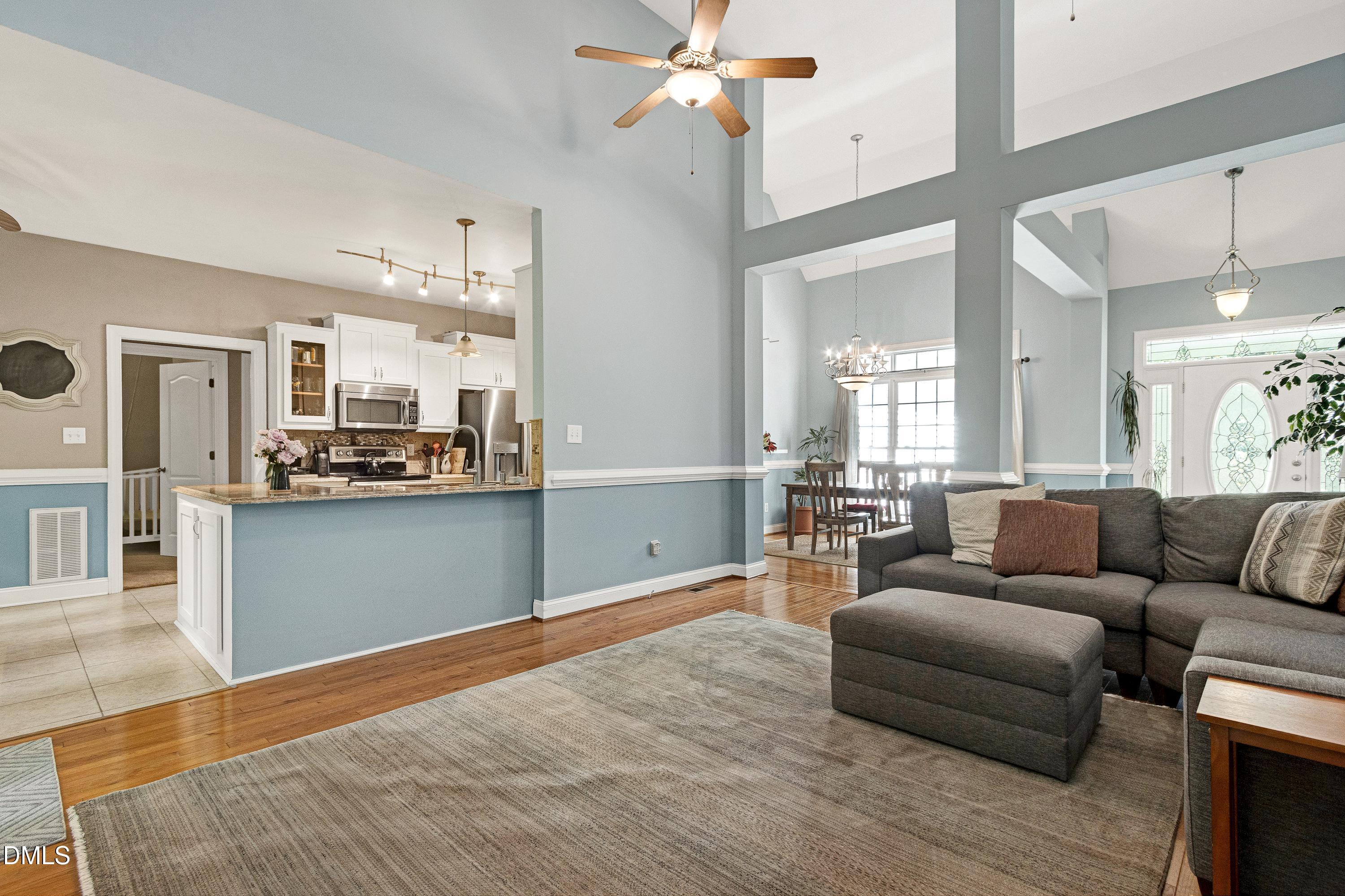 1320 Taylor Farm Road Raleigh, NC 27603 - Photo 14 of 56 a living room with furniture and kitchen view