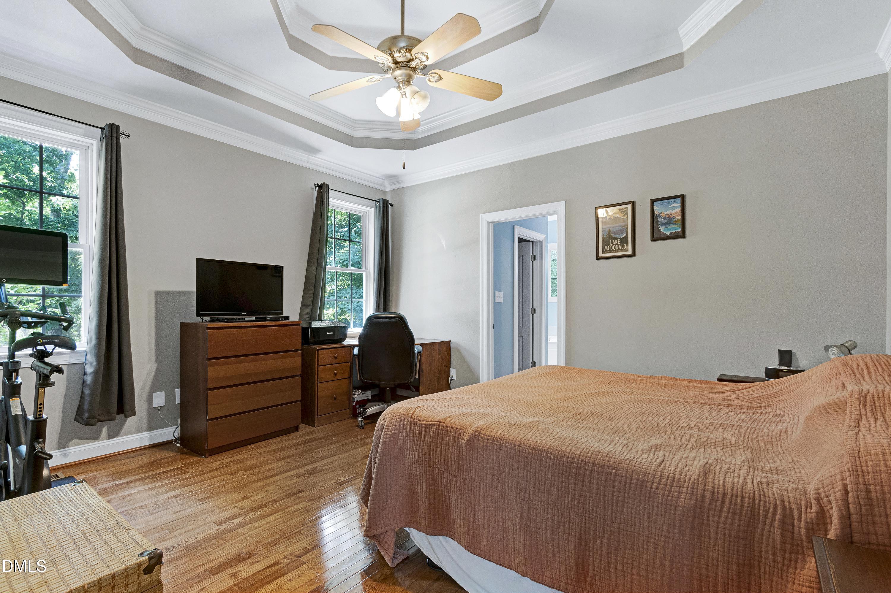 1320 Taylor Farm Road Raleigh, NC 27603 - Photo 23 of 56 a bedroom with a bed and a flat screen tv