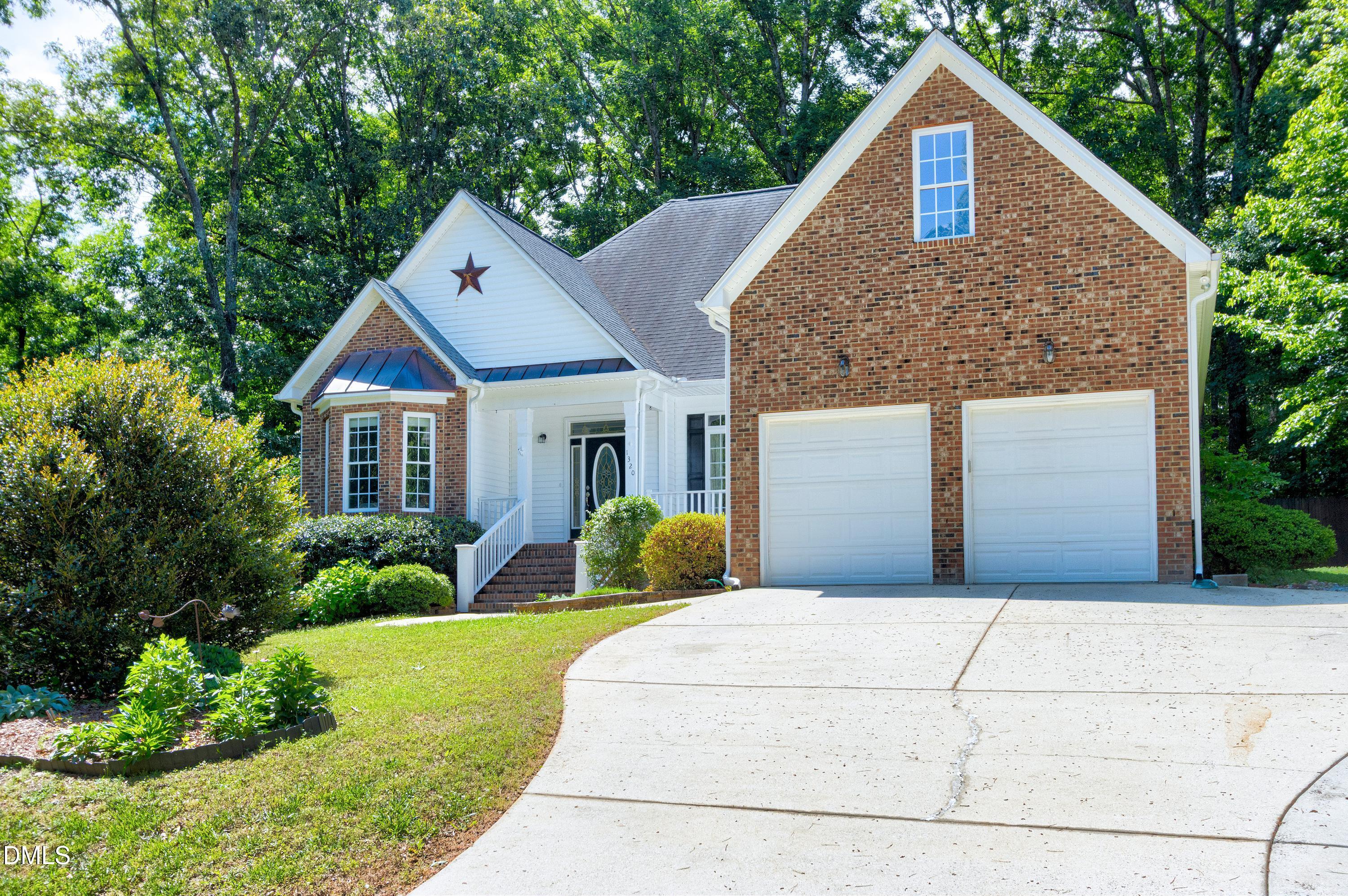 1320 Taylor Farm Road Raleigh, NC 27603 - Photo 2 of 56 a front view of a house with garden