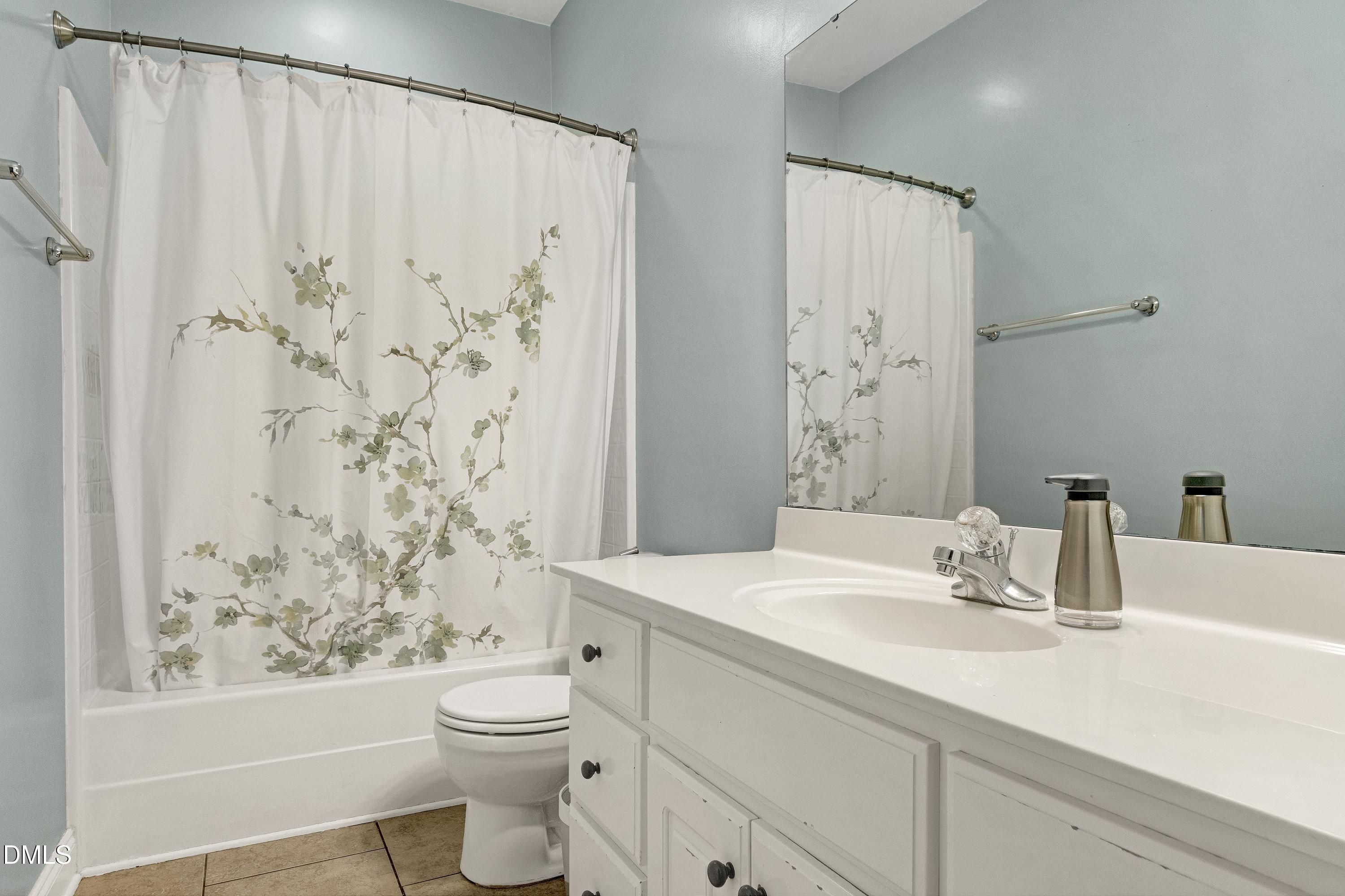 1320 Taylor Farm Road Raleigh, NC 27603 - Photo 28 of 56 a bathroom with a sink a toilet and shower curtain