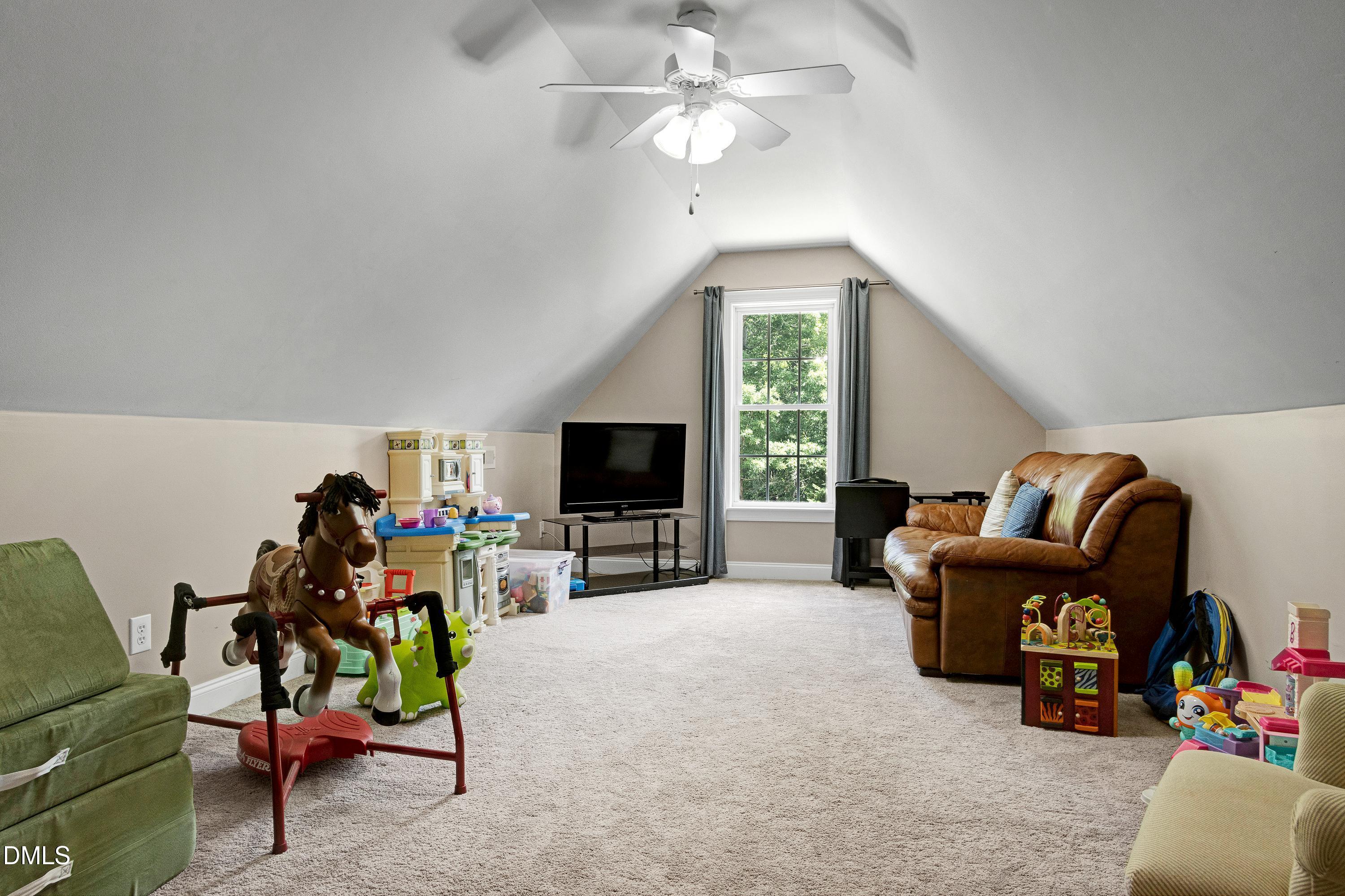 1320 Taylor Farm Road Raleigh, NC 27603 - Photo 30 of 56 a living room with furniture and a flat screen tv