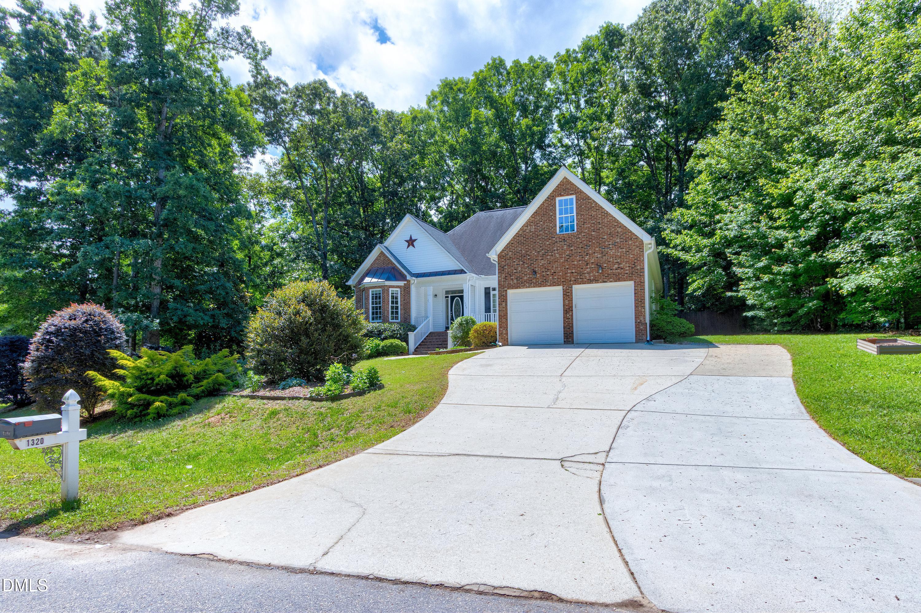 1320 Taylor Farm Road Raleigh, NC 27603 - Photo 32 of 56 a front view of a house with a yard and garage