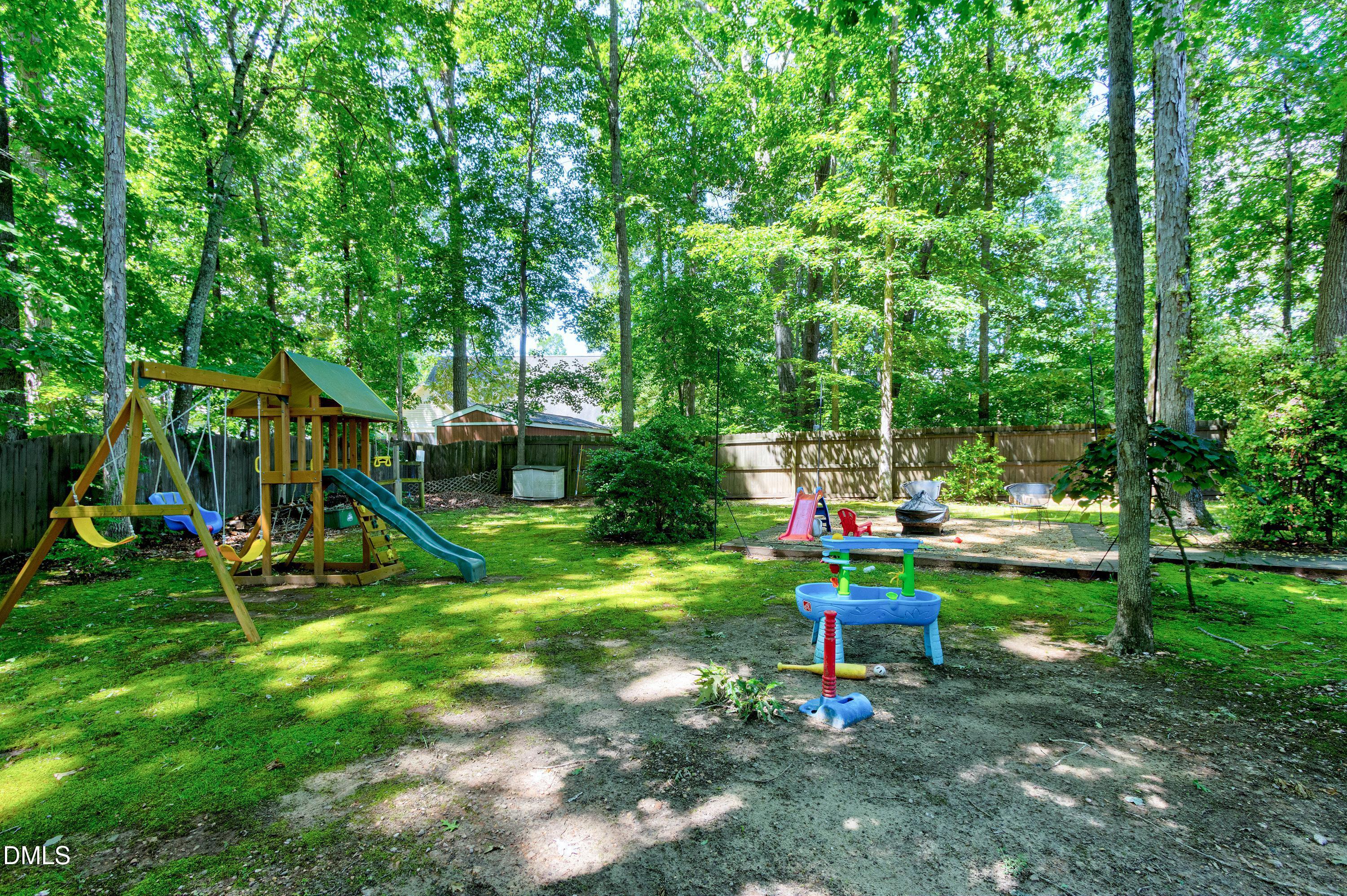1320 Taylor Farm Road Raleigh, NC 27603 - Photo 38 of 56 a view of a park with slide and a child swing