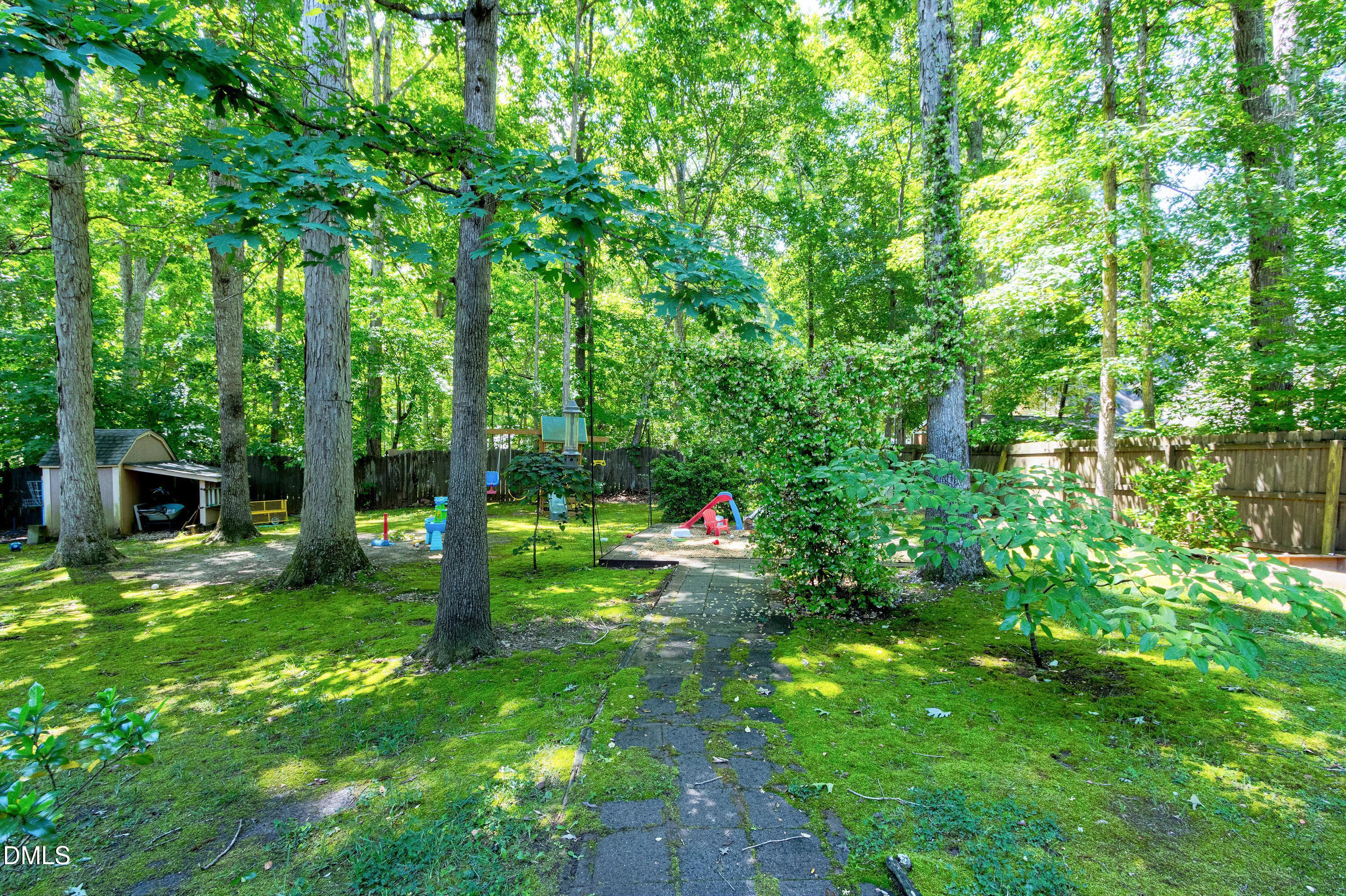 1320 Taylor Farm Road Raleigh, NC 27603 - Photo 41 of 56 a view of an house with backyard space and garden