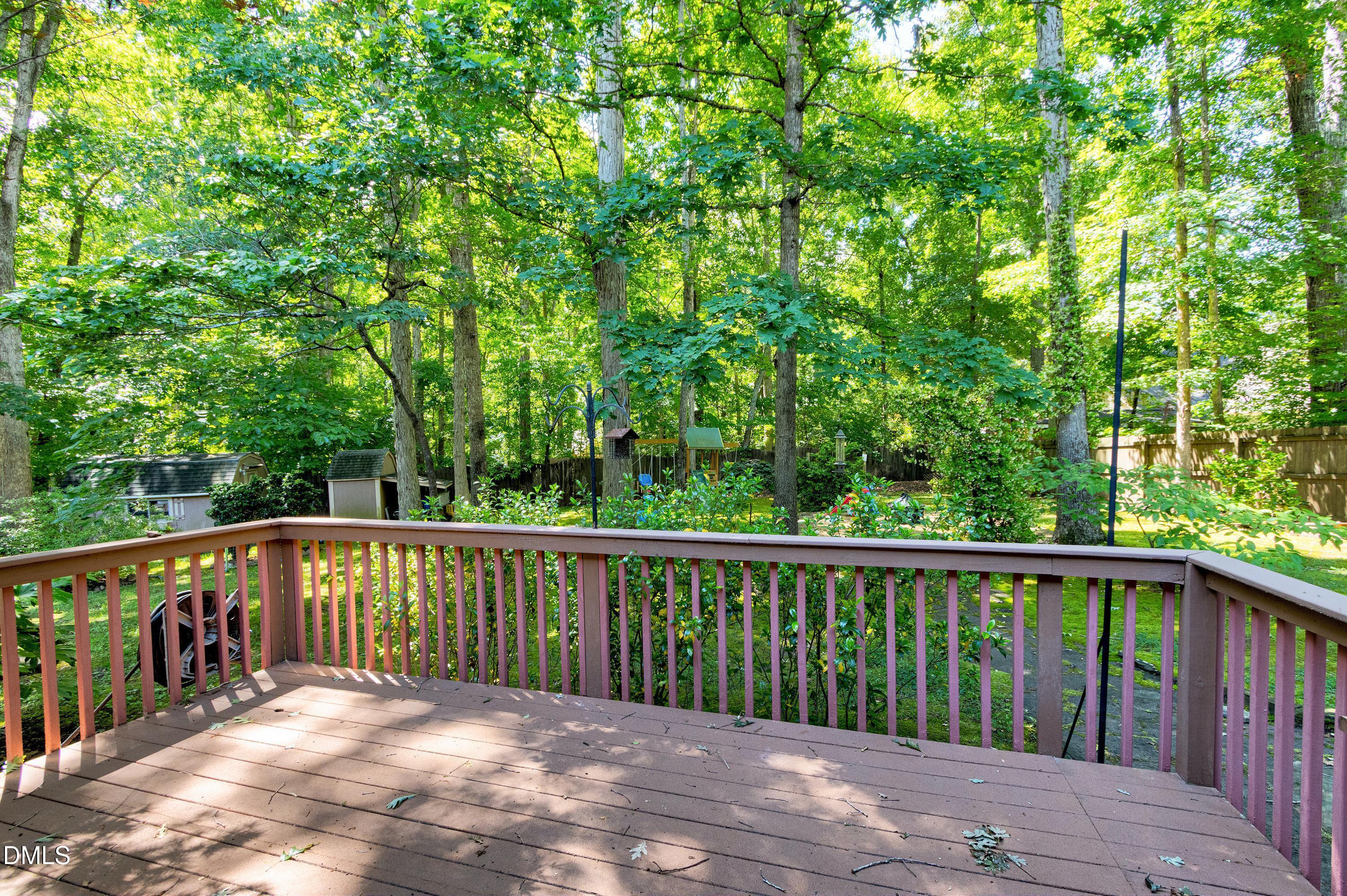 1320 Taylor Farm Road Raleigh, NC 27603 - Photo 42 of 56 a balcony with wooden floor and trees in the back