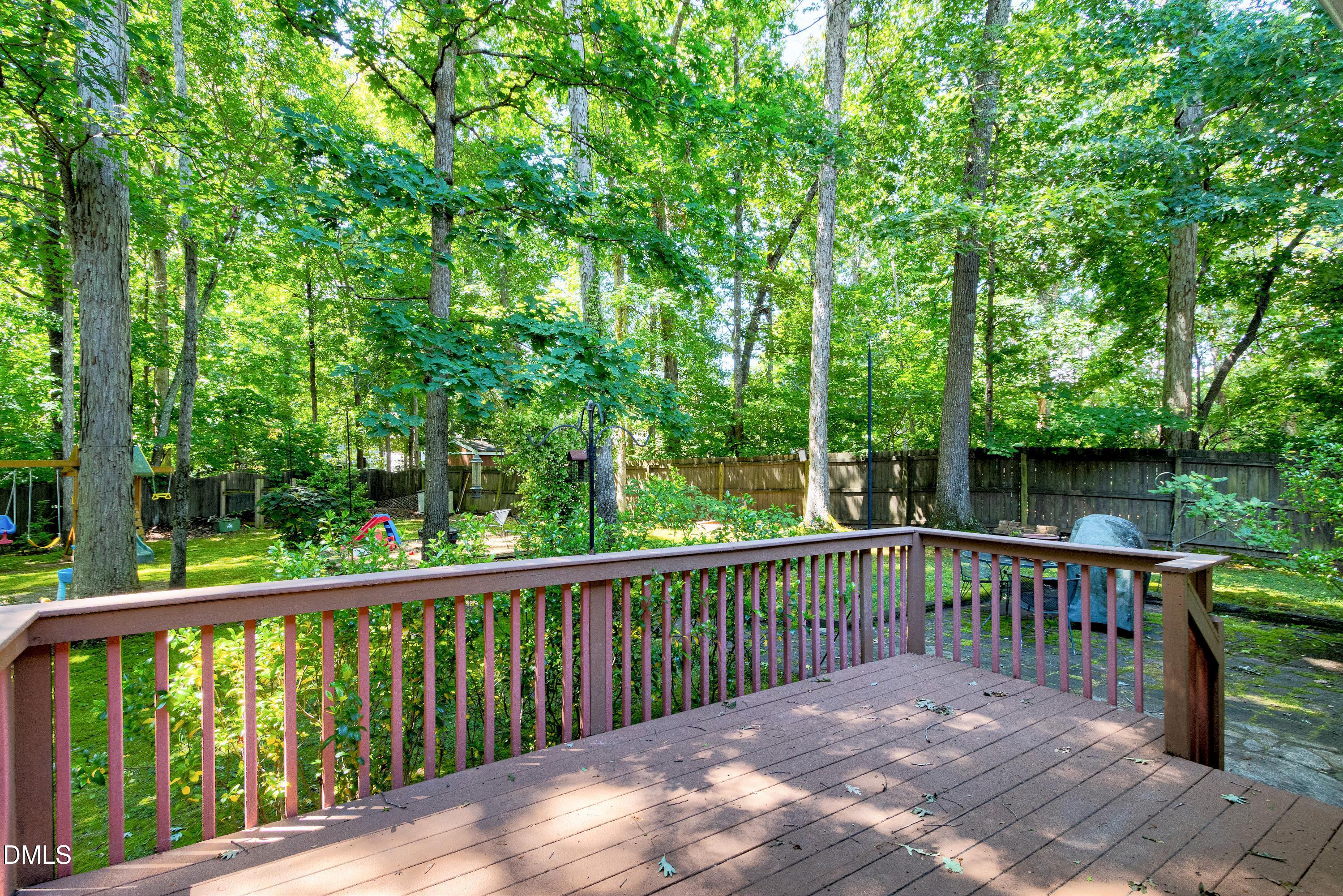 1320 Taylor Farm Road Raleigh, NC 27603 - Photo 43 of 56 a view of a wooden deck and a yard with wooden fence