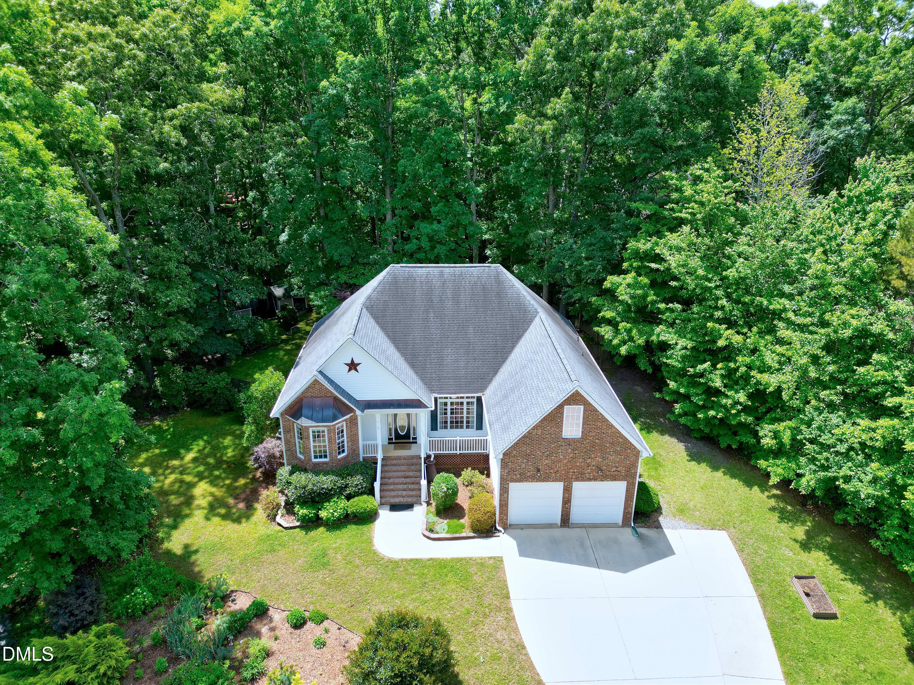 1320 Taylor Farm Road Raleigh, NC 27603 - Photo 45 of 56 a aerial view of a house next to a yard with big trees