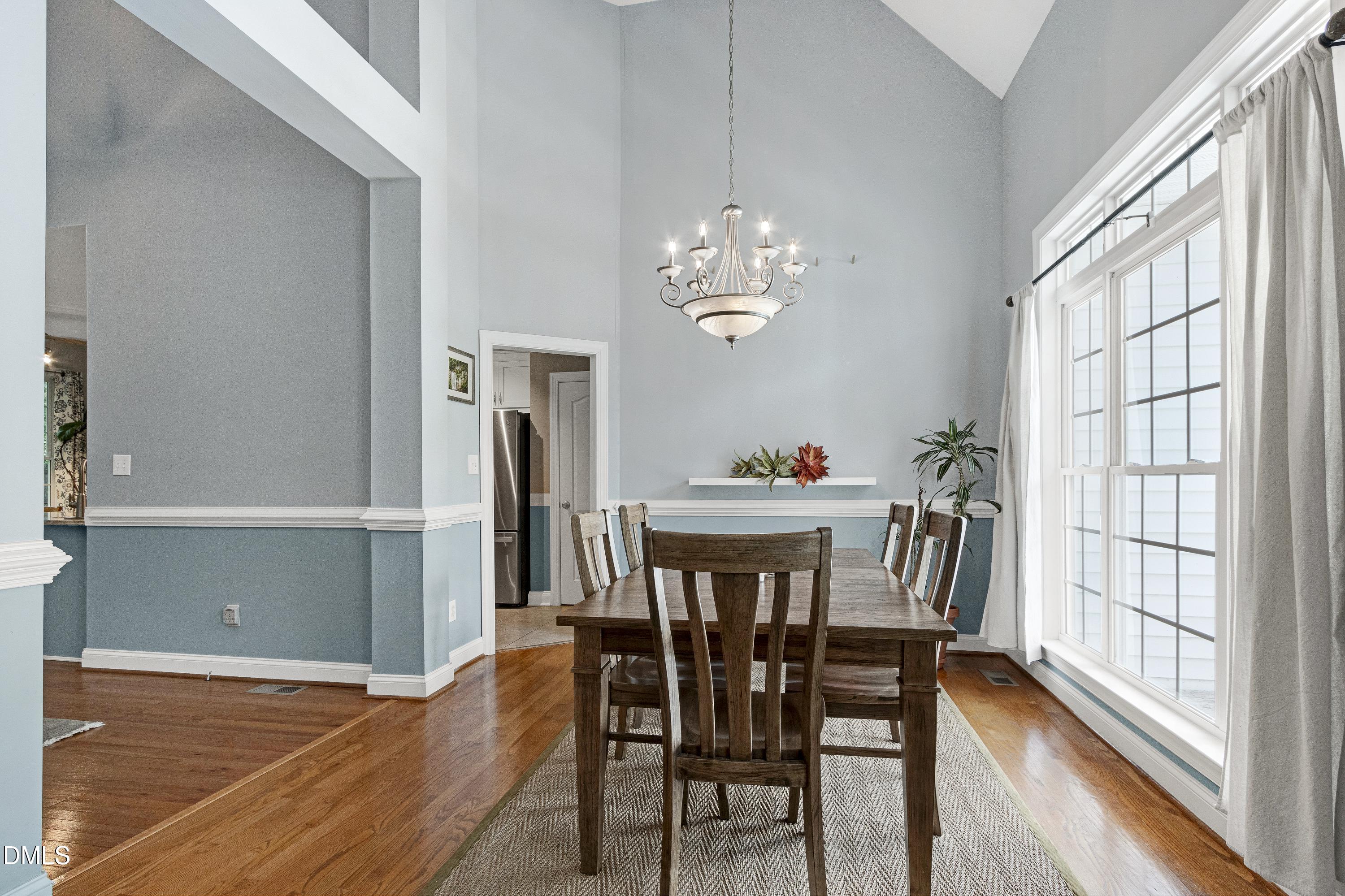 1320 Taylor Farm Road Raleigh, NC 27603 - Photo 7 of 56 a view of a dining room with furniture window and wooden floor