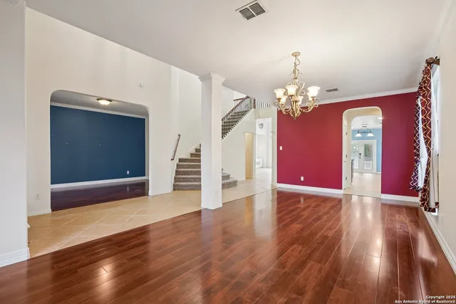 a view of a livingroom with wooden floor and stairs