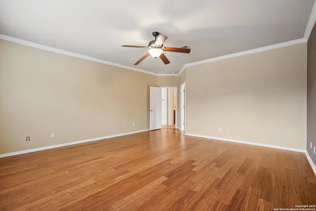 a view of empty room with wooden floor