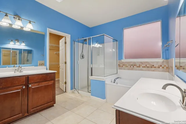 a spacious bathroom with a sink a toilet and shower