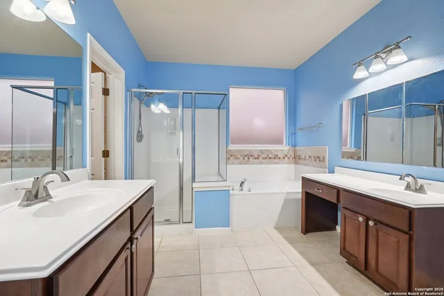 a spacious bathroom with a sink double vanity and a mirror