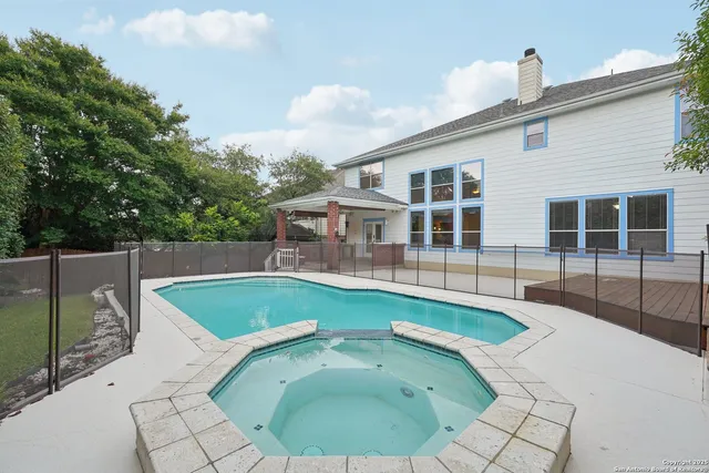 a view of a swimming pool with a yard