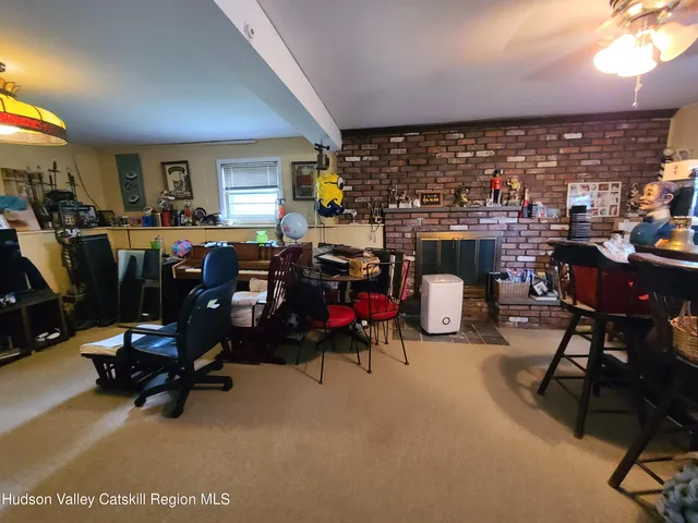 a living room with lots of furniture and a equipment