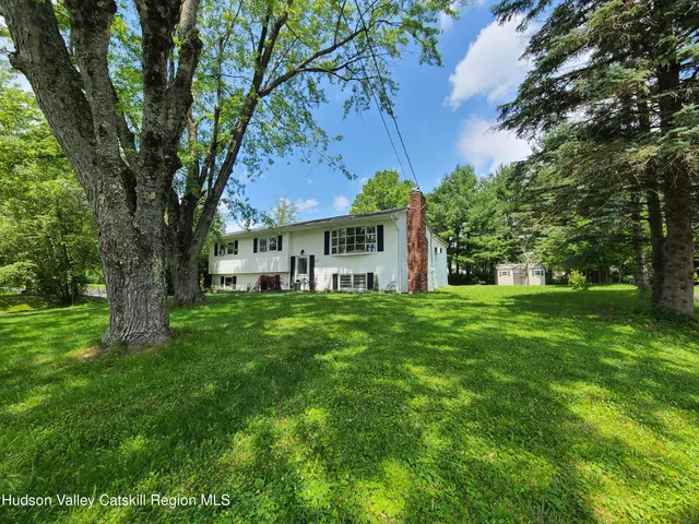 a view of house with a yard