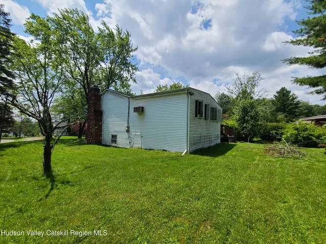 a view of a green field with trees in the background