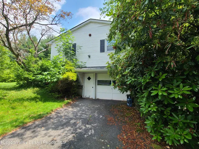 a view of a house with a yard and garage