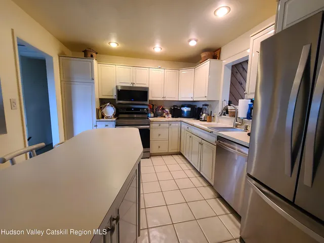 a kitchen with a sink a stove a refrigerator and cabinets