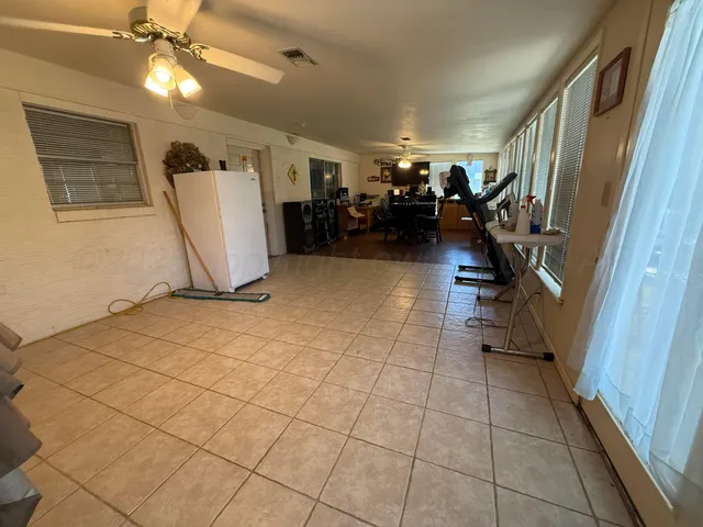 a view of a livingroom with furniture and a ceiling fan