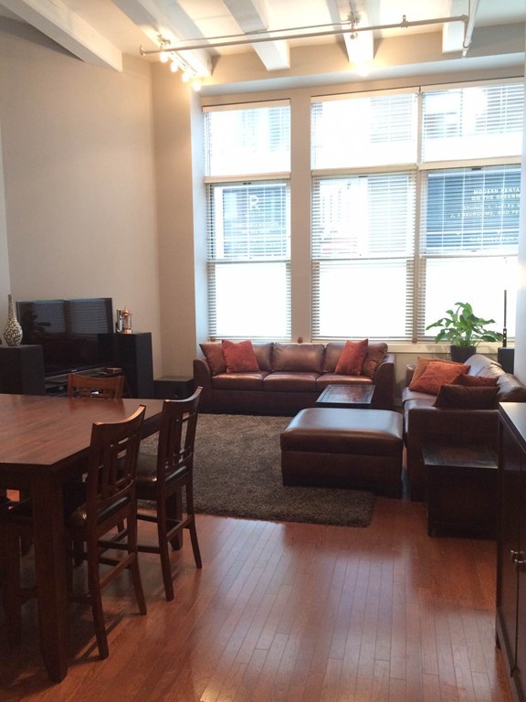 88 Kingston Street, Unit 1E Boston, MA 02111 - Photo 1 of 11 a living room with furniture and a window