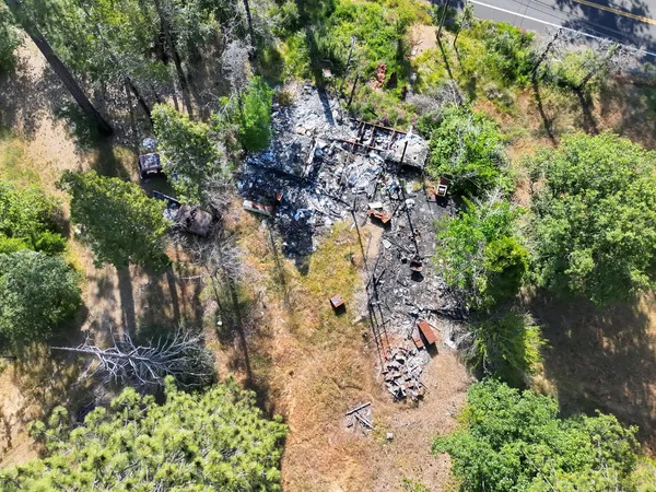 a backyard of a house with lots of green space and a fountain