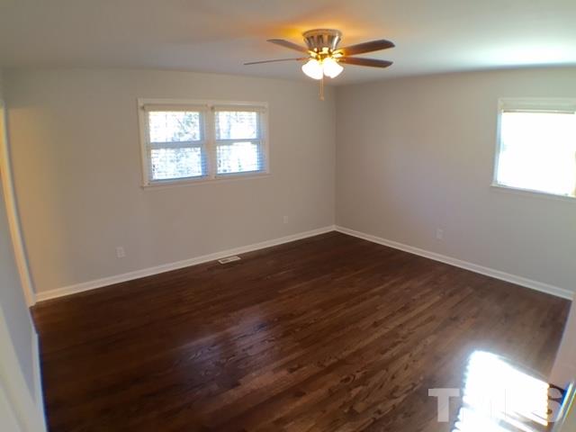 5016 Dantree Place Raleigh, NC 27609 - Photo 11 of 16 wooden floor in an empty room with a window