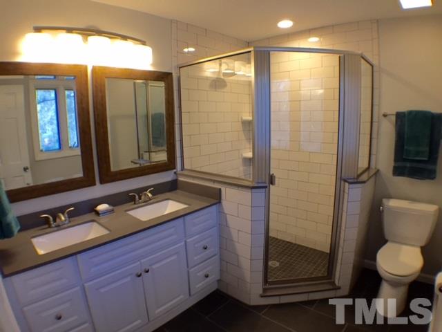 5016 Dantree Place Raleigh, NC 27609 - Photo 12 of 16 a bathroom with a granite countertop sink toilet and shower