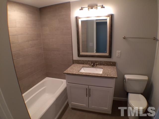 5016 Dantree Place Raleigh, NC 27609 - Photo 15 of 16 a bathroom with a toilet sink and mirror