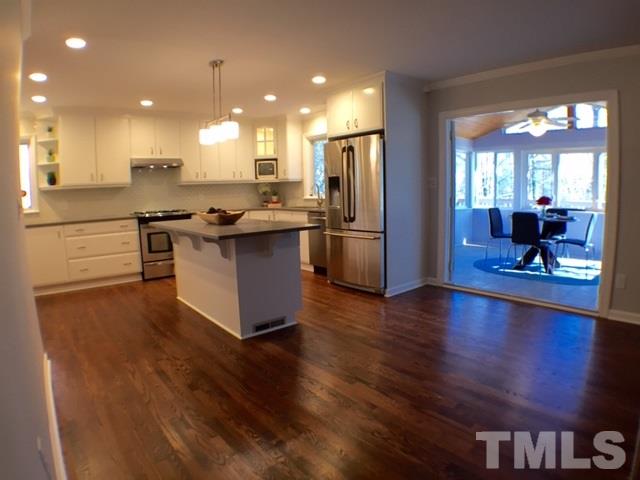 5016 Dantree Place Raleigh, NC 27609 - Photo 3 of 16 a kitchen with stainless steel appliances granite countertop a stove and a refrigerator